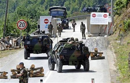 France's KFOR soldiers control the road near the Serbia-Kosovo border crossing in Brnjak